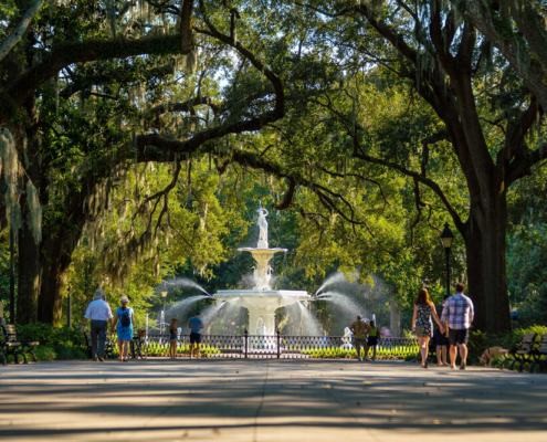 People wandering Forsyth Park, one of the top free things to do in Savannah, GA.