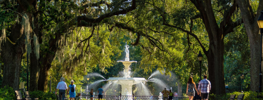 People wandering Forsyth Park, one of the top free things to do in Savannah, GA.